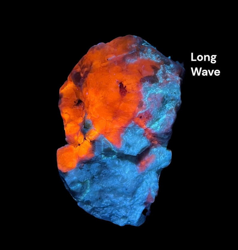 May include: A glowing rock with vibrant orange and blue hues against a black backdrop. The text "Long Wave" is visible on the right. The rock's surface has a rough texture, with the colours creating a striking contrast.