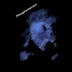 May include: A dark image featuring a blue, cloud-like shape with the word "Phosphorescent" in white text. The blue shape has a textured appearance against a black background.