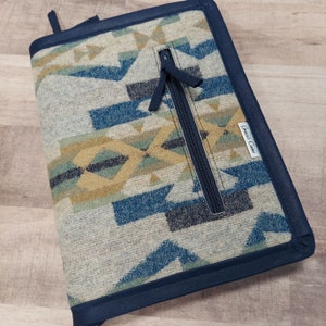 May include: A blue and beige patterned zippered notebook cover with a dark blue border and the text "Great Cases" printed on the side.