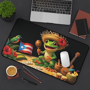 May include: A black desk mouse pad featuring a cartoon frog wearing a straw hat and holding a maraca. The pad includes a Puerto Rican flag, a bird, flowers, a guitar, and a pineapple drink.