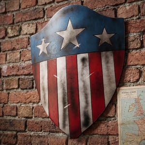May include: A shield with a blue top section featuring three white stars and a red and white striped lower section. The shield is mounted on a brick wall. The shield has a distressed, aged appearance.