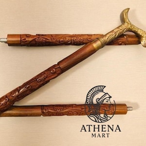 May include: A wooden walking cane with a brass handle and accents. The cane is dark brown with carved floral designs. The handle has an ornate leaf pattern. The cane is in three pieces, with the top piece detached.