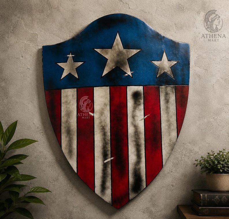 May include: A shield with a blue top section featuring three white stars, and a lower section with red and white stripes. The shield has a distressed, vintage appearance, with signs of wear and tear.