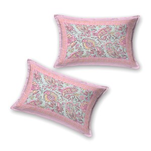 May include: Two rectangular pillowcases with a light blue background and a paisley floral pattern in pink and yellow. The pillowcases have a pink border with a striped design.