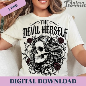 May include: Cream-coloured t-shirt with a graphic of a skull with long hair, horns, and roses, and the text "THE DEVIL HERSELF" above the skull. The words "DIGITAL DOWNLOAD" are at the bottom.