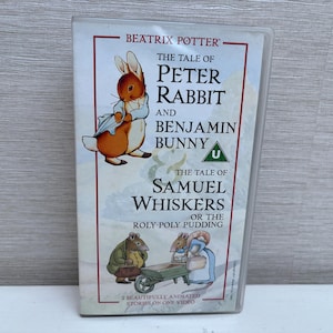 Puede incluir: Una cinta VHS vintage con "The Tale of Peter Rabbit and Benjamin Bunny" y "The Tale of Samuel Whiskers" de Beatrix Potter. La portada presenta ilustraciones de Peter Rabbit y otros personajes. La cinta está en una funda de plástico transparente.