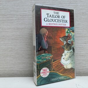 May include: A VHS tape of "The Tailor of Gloucester" by Beatrix Potter. The cover features an illustration of a man and mice in a room. The tape has a "Free Cassette Offer" sticker.