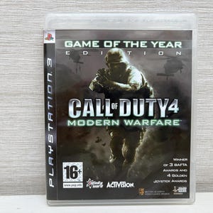 May include: Call of Duty 4: Modern Warfare game for PlayStation 3. The cover shows a soldier in a combat scene with helicopters. The text "Game of the Year Edition" is at the top. Includes BAFTA and Joystick Awards.