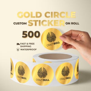 May include: Gold circle stickers on a roll. Each sticker is gold with a black fingerprint design and the text "CRAZYBULL". The image shows a roll of 500 stickers, with the words "GOLD CIRCLE CUSTOM STICKER ON ROLL" at the top.