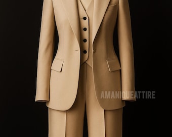 May include: A beige three-piece suit on a mannequin. The suit comprises a blazer with pockets, a waistcoat with black buttons, and matching trousers. The text "AMANIQUEATTIRE" is visible on the lower right.