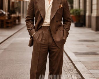 May include: A brown suit with a double-breasted jacket, pleated trousers, and a light-colored shirt. The suit is worn with brown shoes and sunglasses. The image is taken on a cobblestone street.