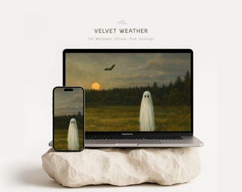 May include: A laptop and smartphone display a spooky landscape wallpaper featuring a ghost in a field at sunset. The devices rest on a light-colored, textured stone. The text "The Velvet Weather" is at the top.