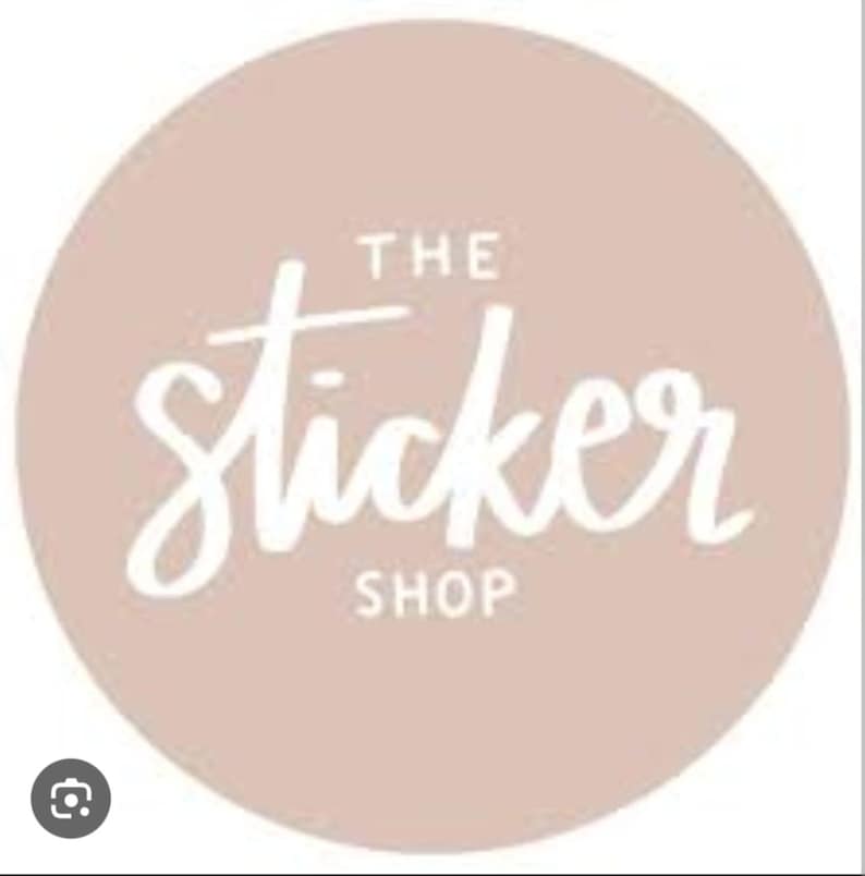 May include: A circular logo with a light dusty pink background featuring the white text THE sticker SHOP centered in the middle. The word sticker is written in a white cursive script font, while THE and SHOP are in block letters.