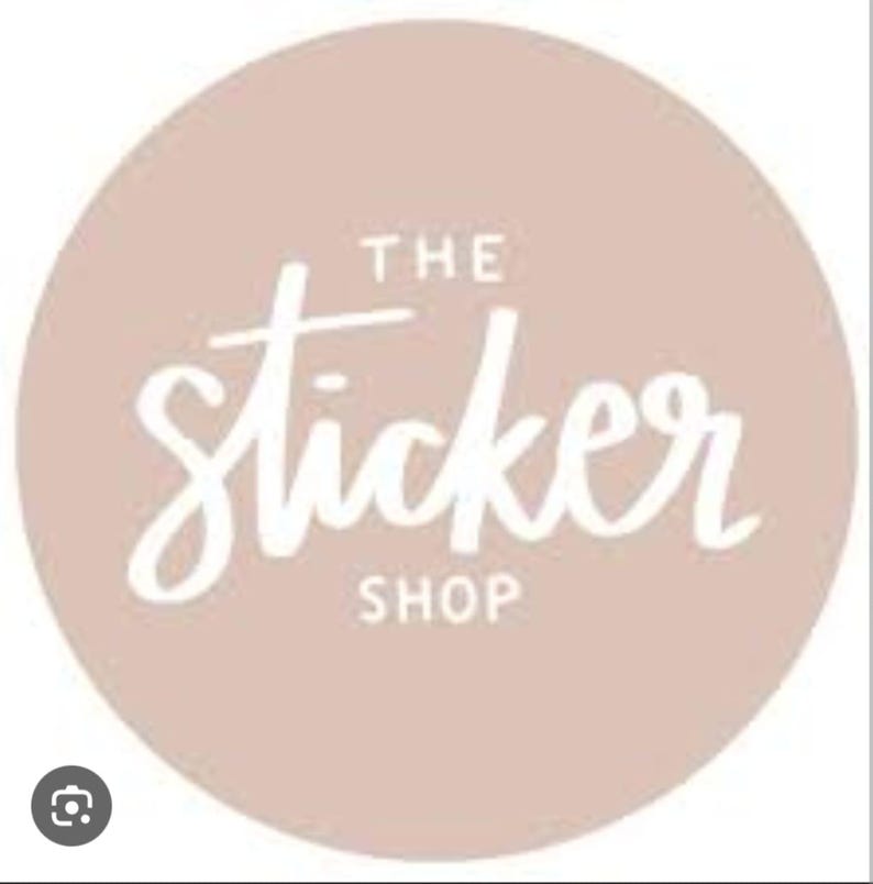 Op de afbeelding: Een cirkelvormig logo met een lichtbruine achtergrond toont de witte tekst "THE Sticker SHOP" in een handgeschreven stijl. Het logo is eenvoudig en strak, geschikt voor branding.