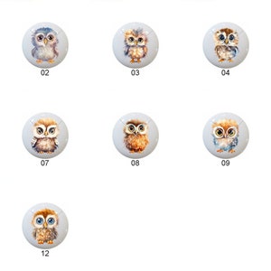 May include: Twelve round, white ceramic ornaments with watercolor owl designs. Each owl has a different color scheme and expression. The ornaments are numbered 1 through 12.
