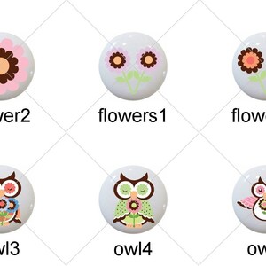 May include: Set of 10 ceramic knobs with various designs, including flowers and owls. The knobs are white with colorful designs.