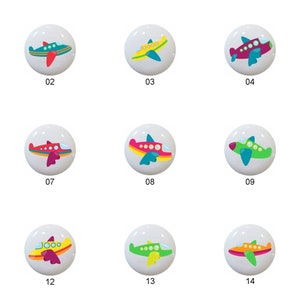 May include: Fifteen colorful ceramic knobs with airplane designs. Each knob features a different color combination and design of an airplane.