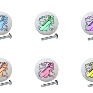 May include: Six ceramic drawer knobs with a ballerina shoe design. Each knob features a white background with a different colored shoe and ribbon. The knobs come with screws for installation.