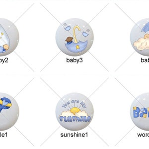 May include: A set of 10 blue and white baby themed ceramic tiles with various designs including a baby boy, a rattle, a giraffe, an umbrella, and the words "You are my sunshine" and "Baby".