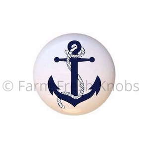May include: A white ceramic knob with a navy blue anchor and white rope design.