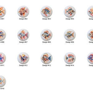 May include: A collection of sixteen ceramic cabinet knobs, each featuring a unique watercolor design of a goldfish. The knobs are round and white, with the fish in various colors like orange, blue, and yellow. Each knob is labeled with a design number.