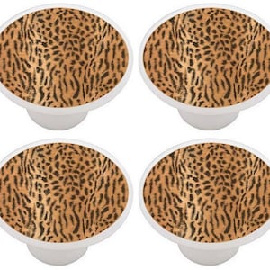 May include: Set of four ceramic cabinet knobs featuring a brown and black leopard print design.