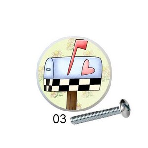 May include: Five different round cabinet knobs with a white background and colorful floral designs. The knobs are attached to silver screws. The designs include daisies, a mailbox with a heart, and a flower growing from a tree stump.