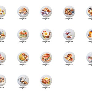 May include: A collection of eighteen white cabinet knobs, each featuring a different watercolor illustration of breakfast foods. Designs include eggs, pancakes, sandwiches, and pastries. Each knob is labeled with a design number.