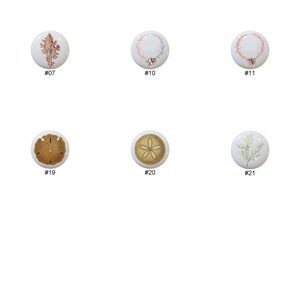 May include: A set of 11 ceramic knobs with various ocean-themed designs, including seashells, starfish, seahorses, and coral. The knobs are white with a glossy finish.