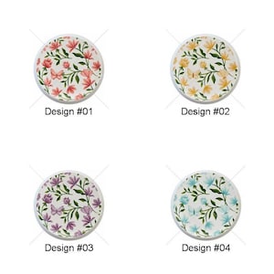 May include: Four round decorative coasters with floral designs. Design #01 features pink flowers and butterflies. Design #02 has yellow flowers. Design #03 showcases purple flowers, and Design #04 displays blue flowers. Each coaster has a white border.