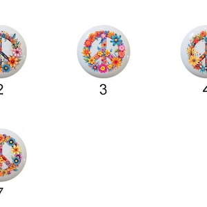 May include: Seven colorful peace sign designs with floral accents. Each design features a white peace sign surrounded by a wreath of flowers in various colors, including red, orange, yellow, green, blue, and purple.