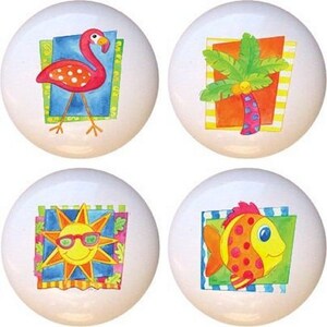 May include: Set of four ceramic knobs featuring colorful illustrations of a flamingo, palm tree, sun, and fish. The knobs are perfect for adding a touch of whimsy to any room.