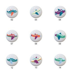 May include: Fifteen ceramic knobs with airplane designs. Each knob features a different color scheme and airplane design. The knobs are numbered 1 through 15.