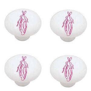 May include: Set of four white ceramic cabinet knobs with pink ballet shoe designs.