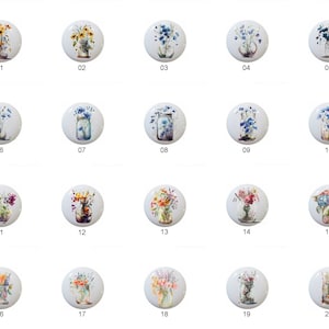 May include: A collection of twenty white ceramic cabinet knobs, each featuring a different floral design. The knobs showcase various flowers in vases and jars, with a numbered label from 01 to 20. The floral arrangements include sunflowers, bluebells, and hydrangeas.
