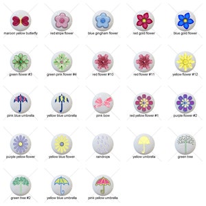 May include: A set of 20 round ceramic tiles with various designs, including flowers, butterflies, umbrellas, raindrops, and trees. The tiles are white with colorful designs.