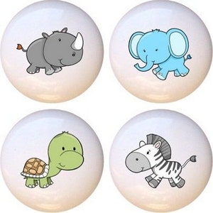 May include: Set of four ceramic knobs featuring cartoon animal illustrations. The knobs are white with a glossy finish. The animals are a rhino, an elephant, a turtle, and a zebra.