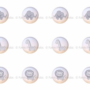 May include: Set of 12 white ceramic drawer knobs with gray animal illustrations. The animals include an elephant, giraffe, and lion. The knobs are perfect for a nursery or child's room.