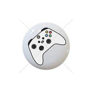 May include: White ceramic knob with a black and white illustration of a video game controller.