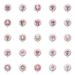 May include: Twenty-five different designs of pink and white floral arrangements on white ceramic tiles. The designs include bouquets, wreaths, and single flowers.
