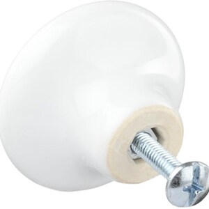 Peut inclure: Bouton de porte en c&eacute;ramique blanche avec une vis argent&eacute;e. Le bouton est rond et a un bord l&eacute;g&egrave;rement sur&eacute;lev&eacute;.