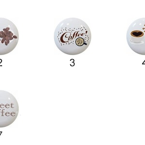 May include: Seven white ceramic knobs with different coffee-themed designs. The designs include coffee beans, coffee cups, and the words "Coffee!" and "Sweet Coffee".