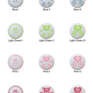 May include: Twelve ceramic knobs with a heart design in four different colors: blue, light green, pink, and red. Each color has three variations of the heart design.