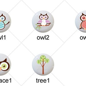 May include: Nine ceramic knobs with various designs, including hearts, owls, and a tree. The knobs are white with colorful designs.