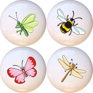 May include: Set of eight ceramic knobs featuring colorful cartoon insects, including a ladybug, butterfly, dragonfly, bee, and more.