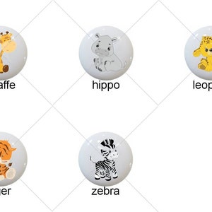 May include: Set of nine ceramic knobs featuring various animals, including an elephant, giraffe, hippo, leopard, lion, monkey, tiger, zebra. Each knob is white with a colorful animal illustration.