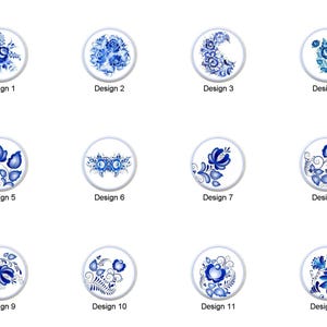 May include: A collection of twelve round designs featuring blue floral patterns on a white background. Each design is labeled with the word "Design" followed by a number. The floral patterns vary, including roses, bouquets, and stylized flower arrangements.