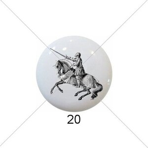 May include: Five round ceramic tiles with different designs. The first tile features a black and white illustration of a person riding a horse. The second tile features a black and white illustration of a person riding a horse. The third tile features a black and white illustration of a person riding a horse. The fourth tile features a green, yellow, and white mandala design. The fifth tile features a brown and white mandala design.