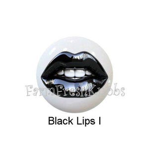 May include: A white ceramic knob featuring a glossy black lip design with white teeth. The text "Black Lips I" is displayed below the knob. The knob has a FarmFreshKnobs logo.