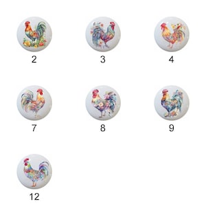 May include: Twelve different ceramic knobs featuring colorful rooster illustrations. Each knob is round and white with a different rooster design.